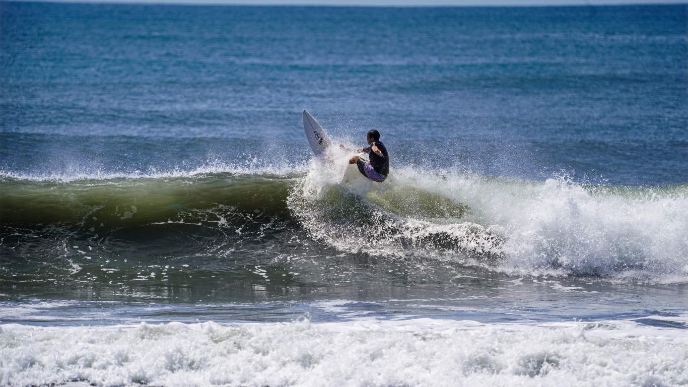 man on a surfboard catching a wave in Nicaragua